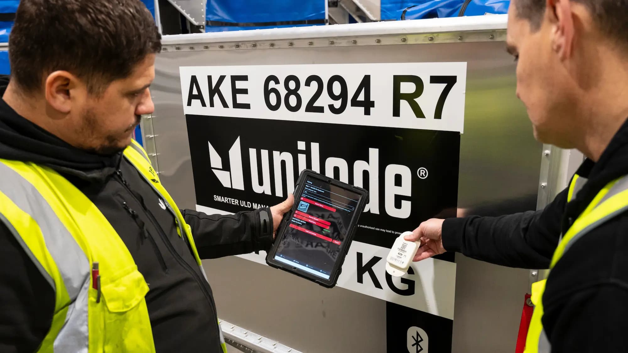 Digitally tagged ULD being scanned by ground crew
