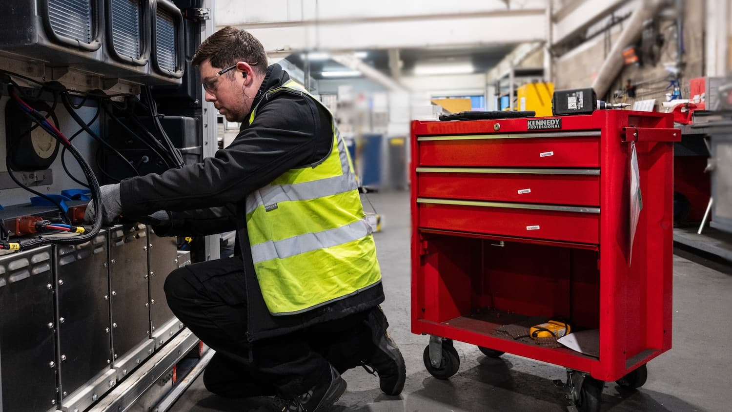 Unilode technician repairing a ULD in a maintenance workshop