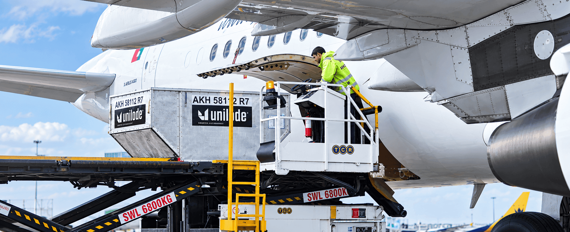 A ULD being loaded into the hold of an aircraft on stand