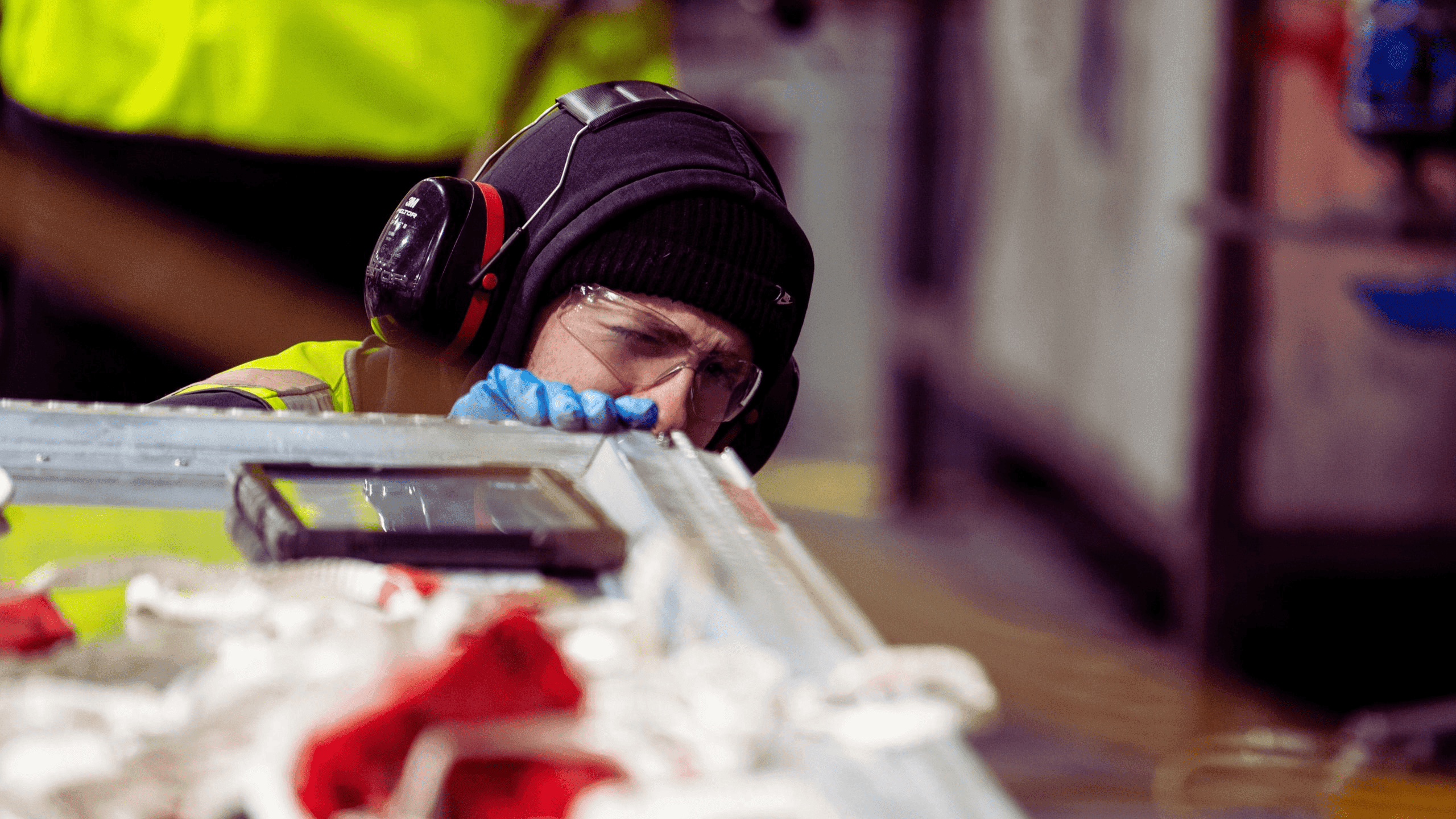 Technicians working on a ULD inside a Unilode repair station